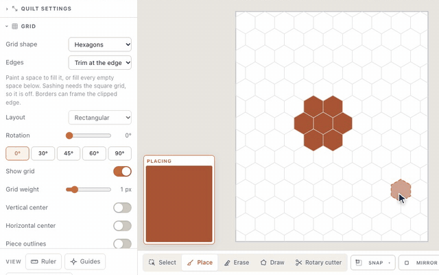 On a blank quilt, Grid shape set to Hexagons redraws the grid as hexagons; with Place, clicking seven of them lays a rust hexagon flower